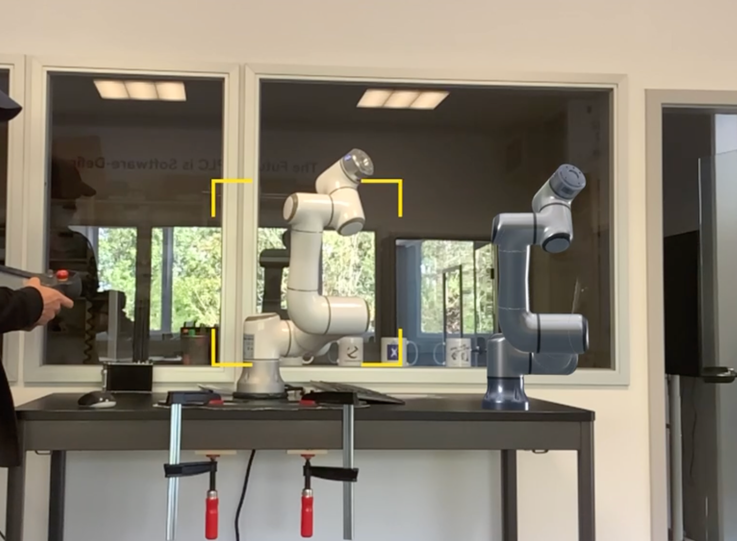 AR-assisted digital twin view of collaborative robots in a lab setup